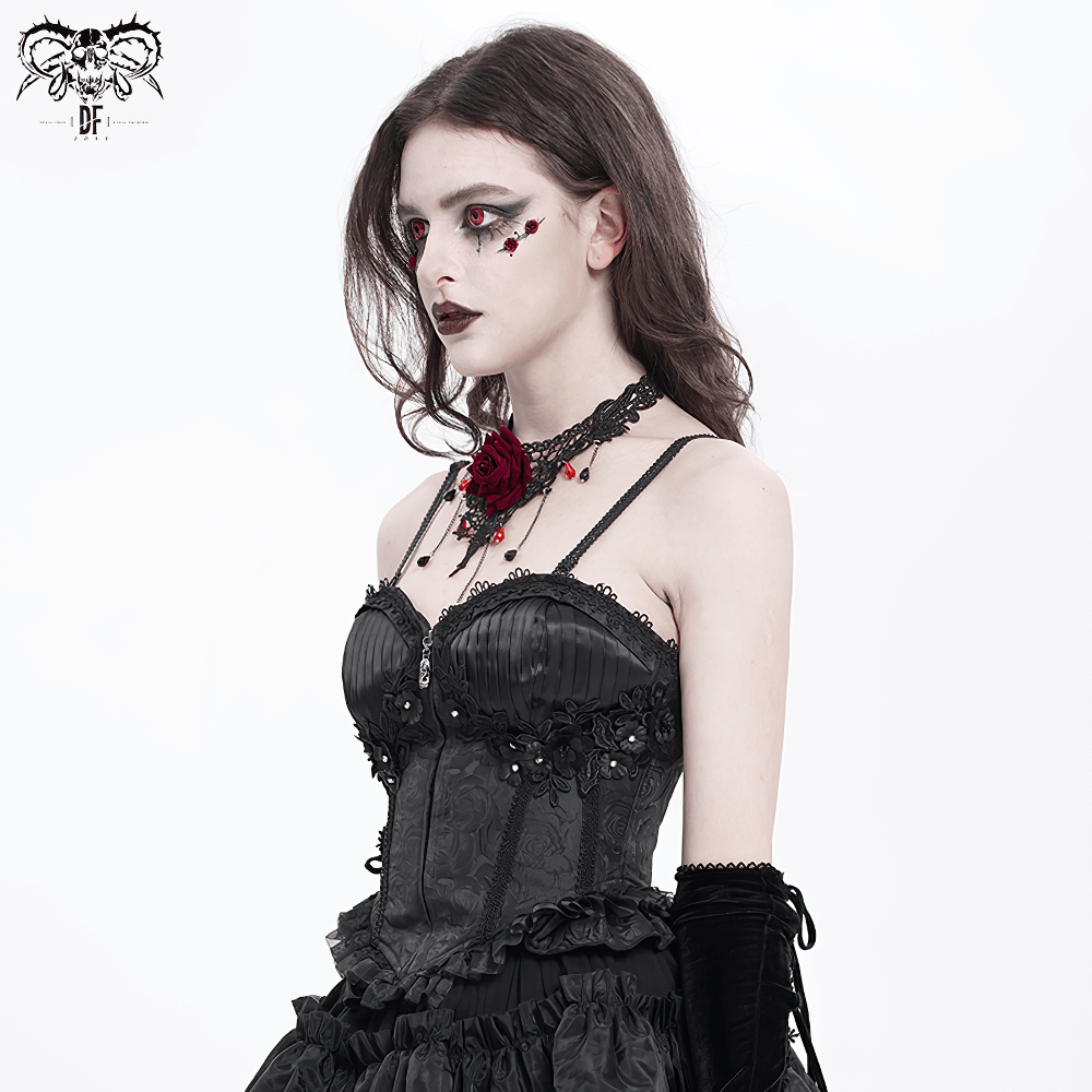 Gothic corset with floral embellishments and ruffled hem, worn by model with dark makeup and dramatic accessories.