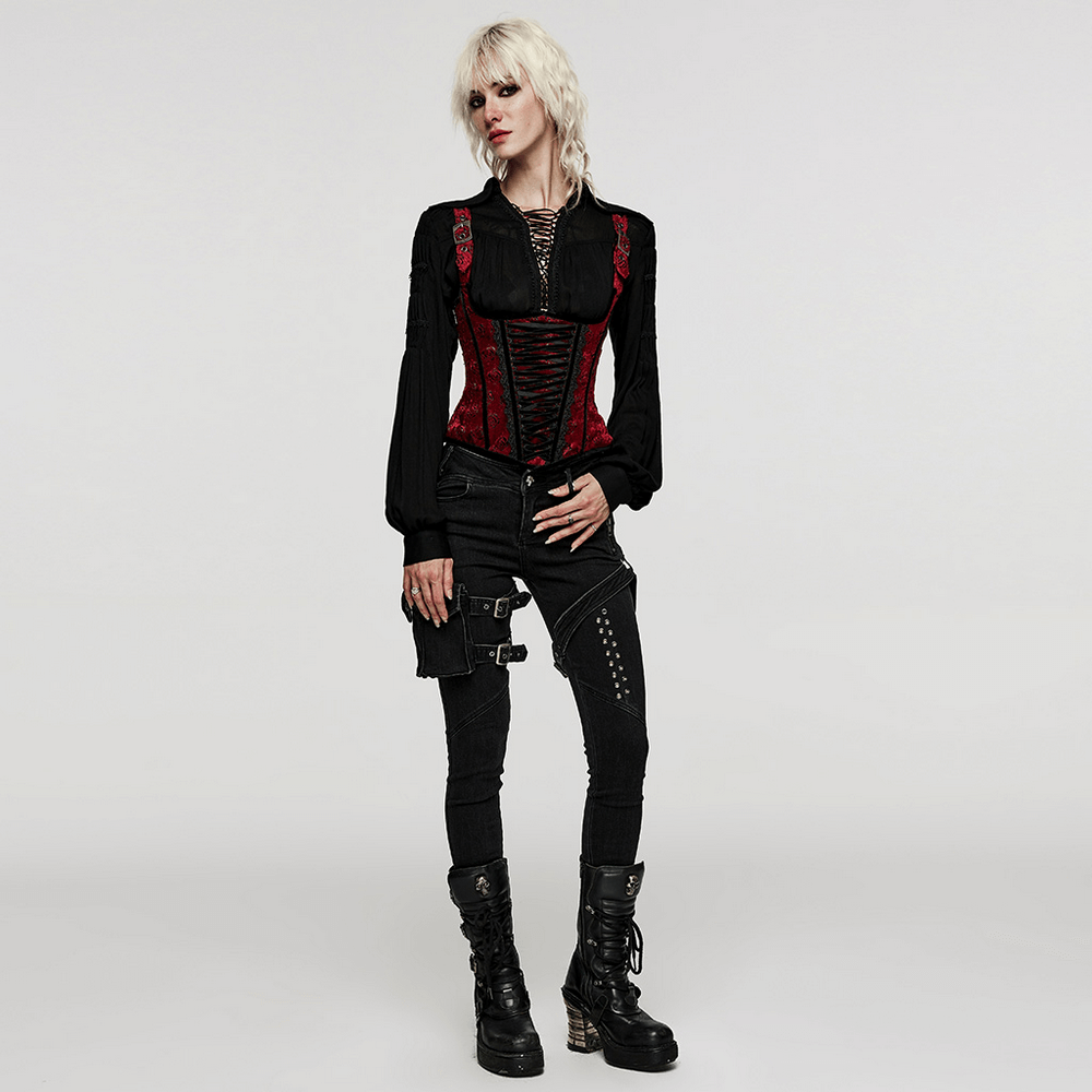 Gothic fashion model wearing a black lace-up blouse with pleated sleeves and red corset details.