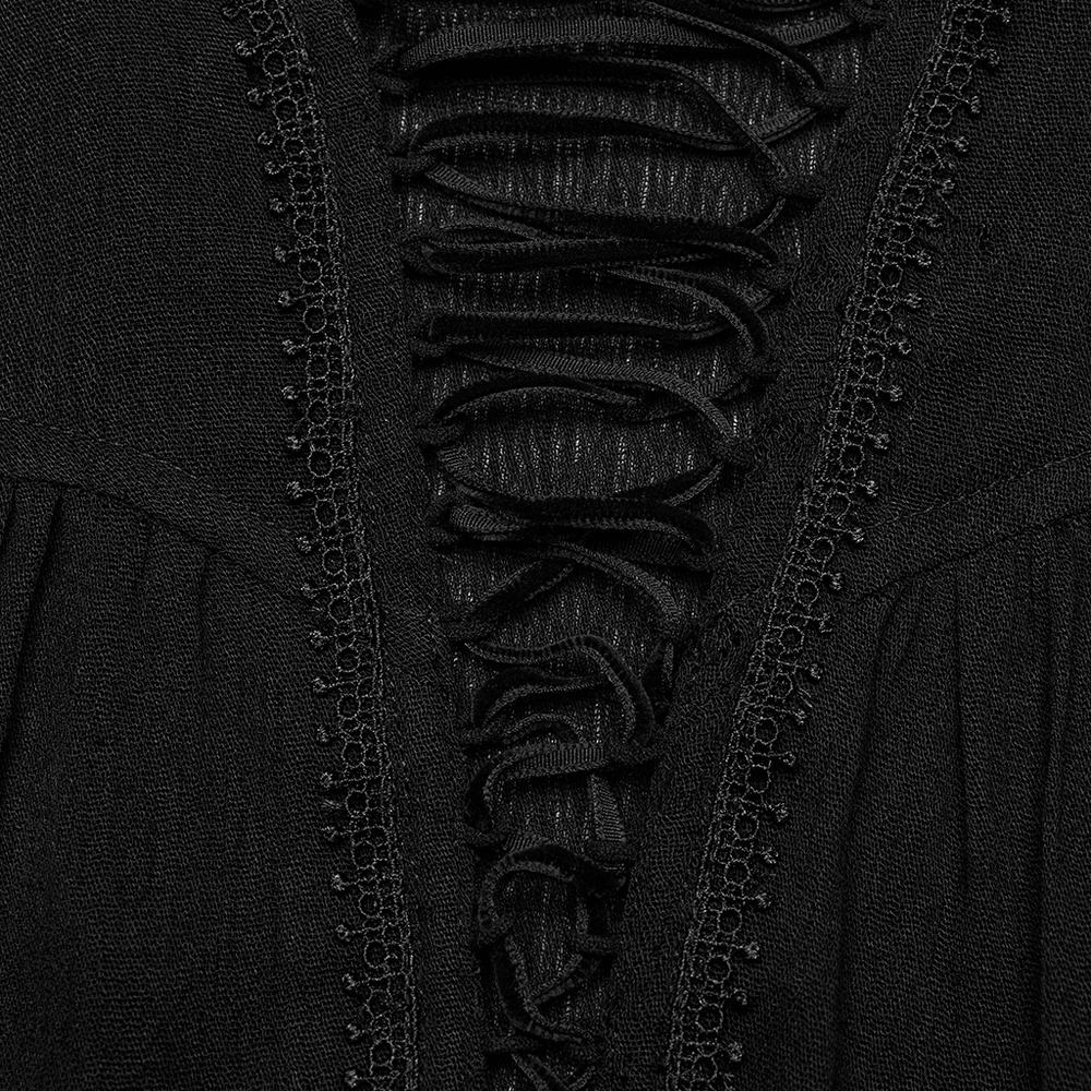 Close-up of lace-up detailing and pleats on a black gothic blouse for women.