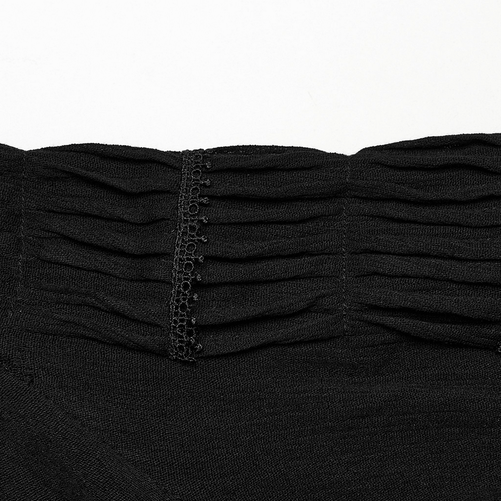 Close-up of black lace-up gothic blouse pleated detail showcasing textured fabric and delicate lace trims.