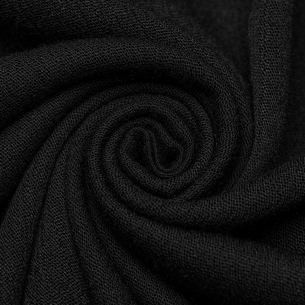 Close-up of soft black fabric, perfect for a gothic blouse with pleats and lace details.