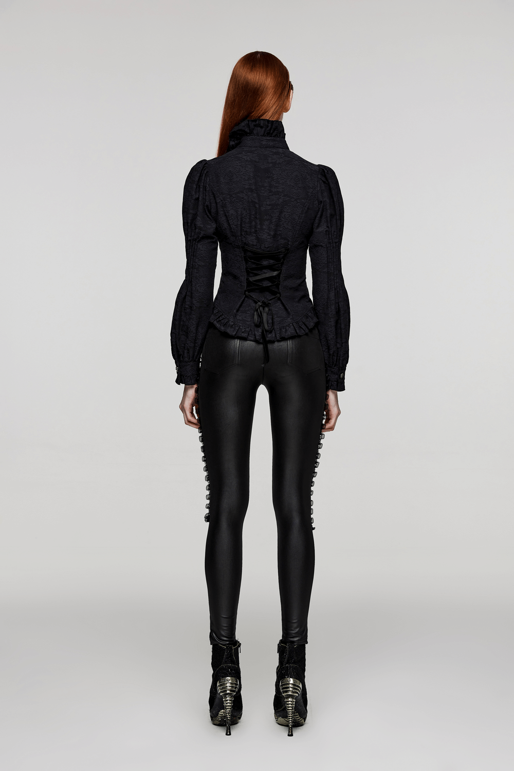 Woman in black lace-up mesh gothic leggings and stylish puffy sleeve top, showcasing edgy gothic style from the back.