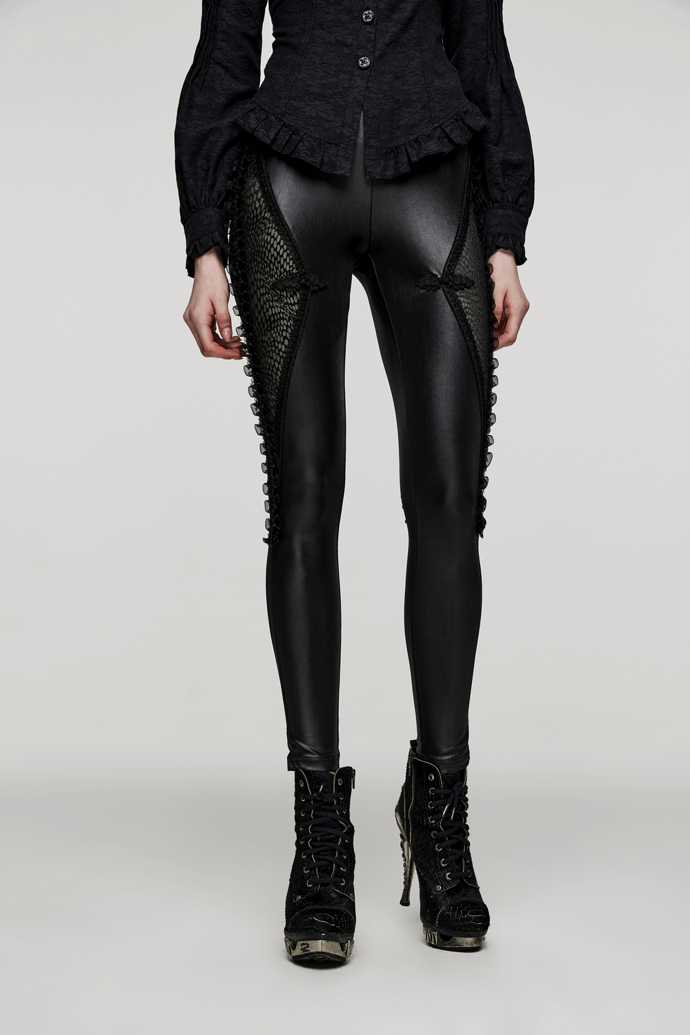 Gothic style lace-up mesh-panel leggings featuring a slim fit for an edgy look, styled with black boots.
