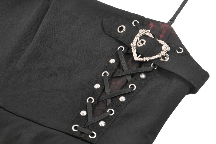 Close-up of lace-up details on a punk rock mini dress with a heart embellishment and rebellious style.