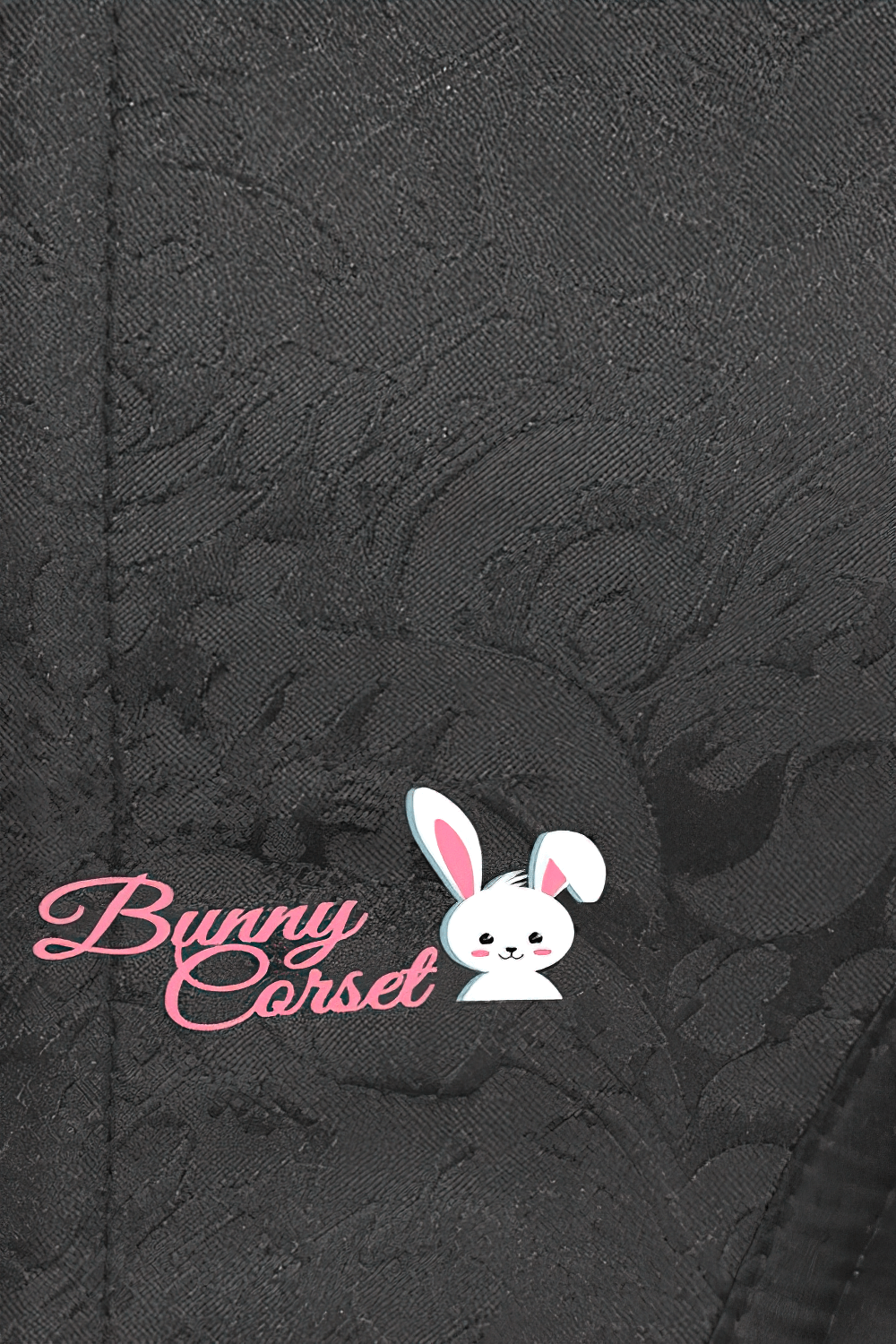 Close-up of black lace corset fabric featuring Bunny Corset logo with cute bunny design.