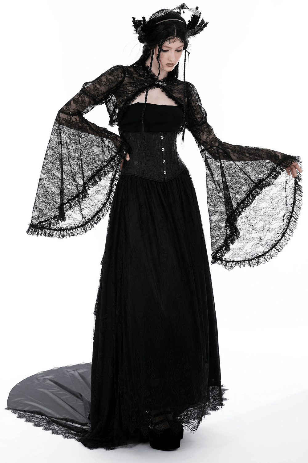 Gothic Victorian woman in a black lace bolero shrug top with long flared sleeves and elegant dress.