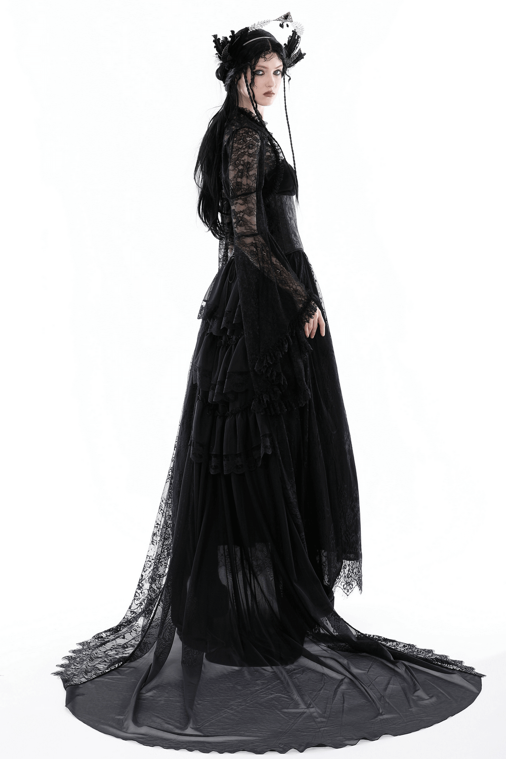 Gothic woman in a stunning black lace dress with a long train and intricate details, embodying Victorian elegance.