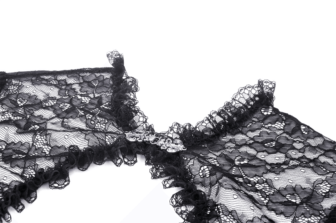 Close-up of a black lace Victorian bolero shrug with ruffled edges and decorative fastening.