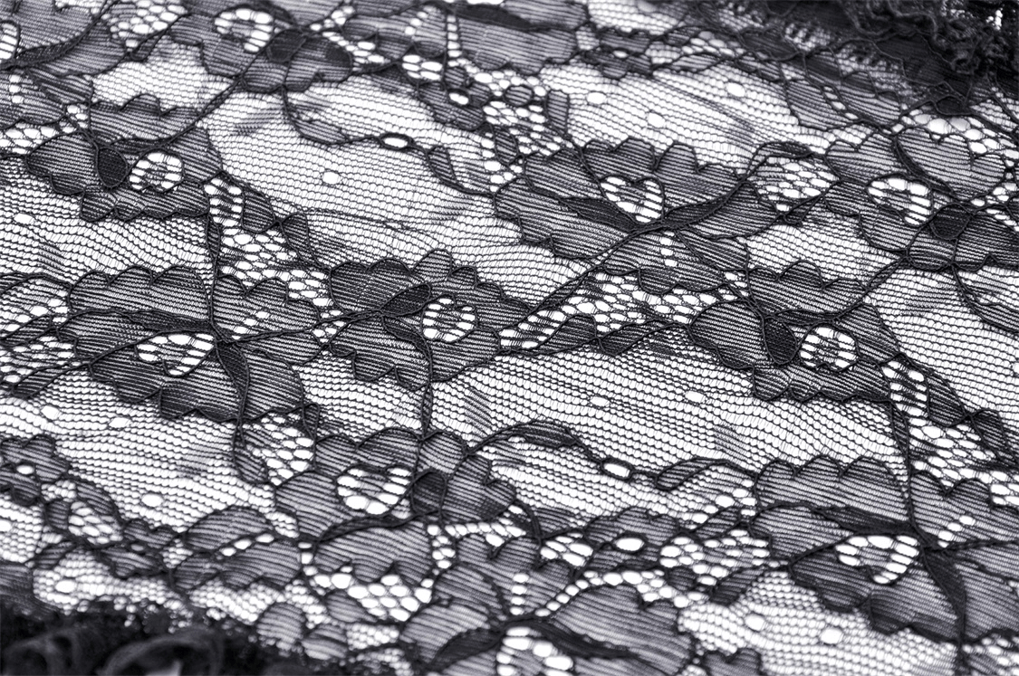 Close-up of beautiful black lace fabric featuring floral patterns and fine detailing, perfect for gothic fashion.