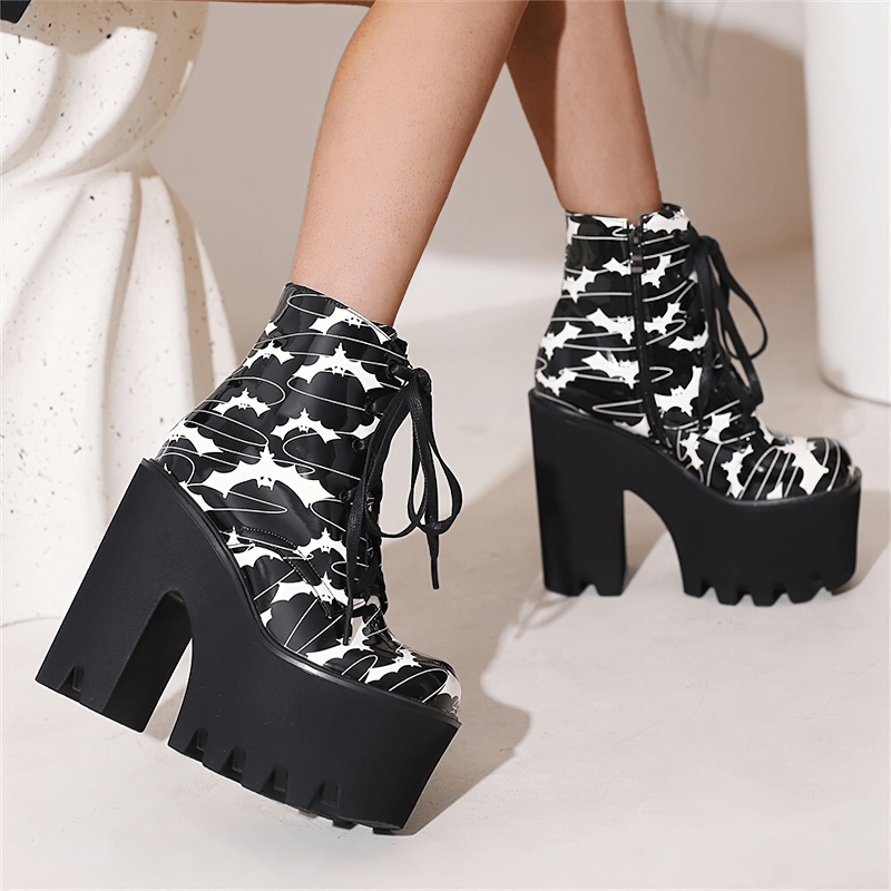Ladies goth platform ankle boots with bats print, showcasing striking style and chic thick high heels.