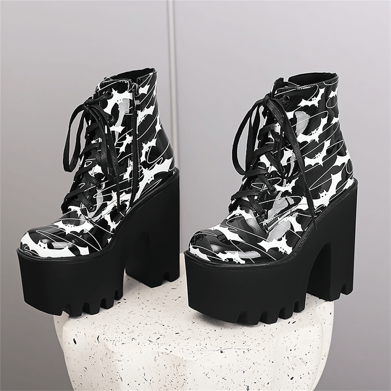 Ladies goth platform ankle boots with bat print on a stylish pedestal for modern gothic fashion.