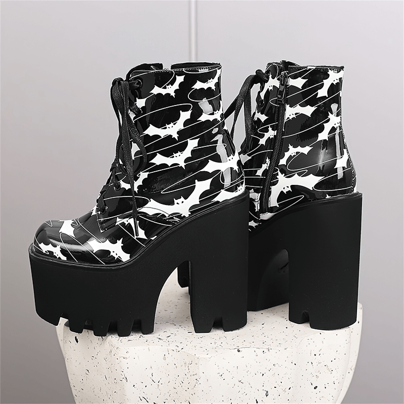 Ladies goth platform ankle boots with bat print, featuring thick black heels for stylish elegance.