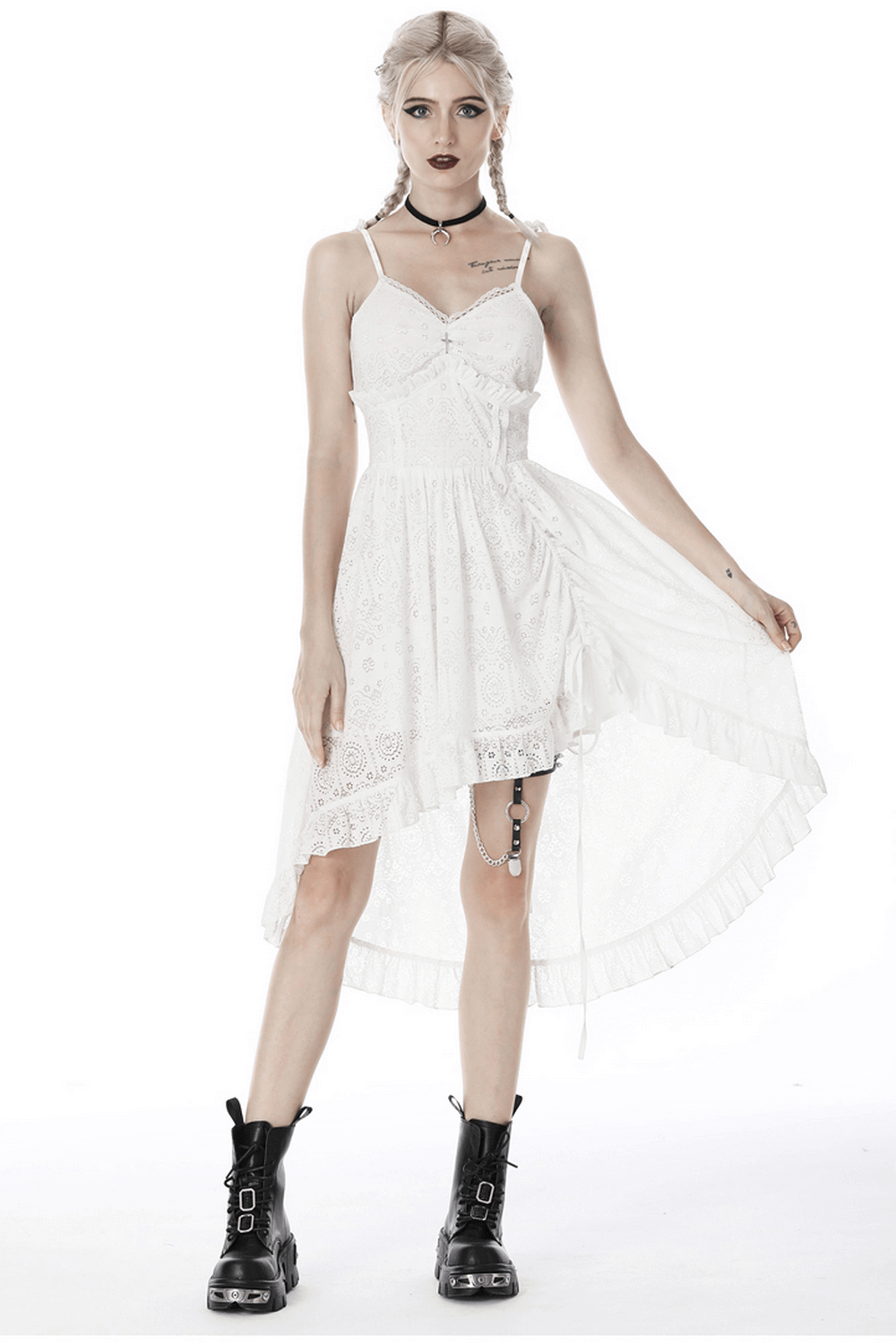 Gothic white lace midi dress with asymmetric hem, styled with daring black boots for a bold look.