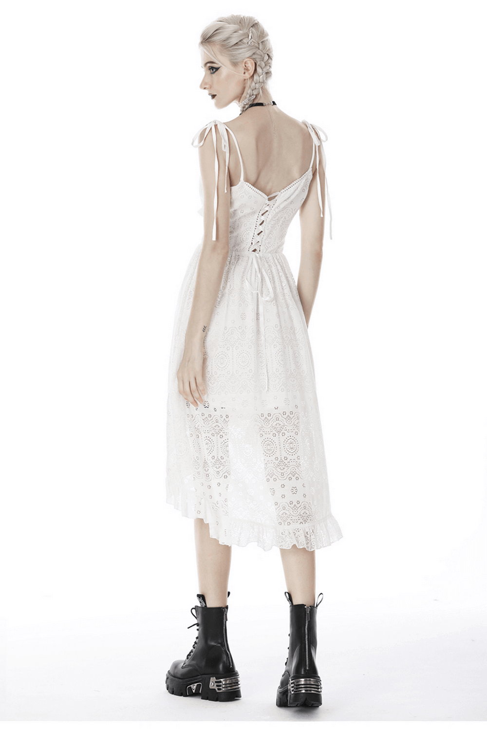 Ladies gothic white lace midi dress with asymmetric hem and lace details, styled with black boots.