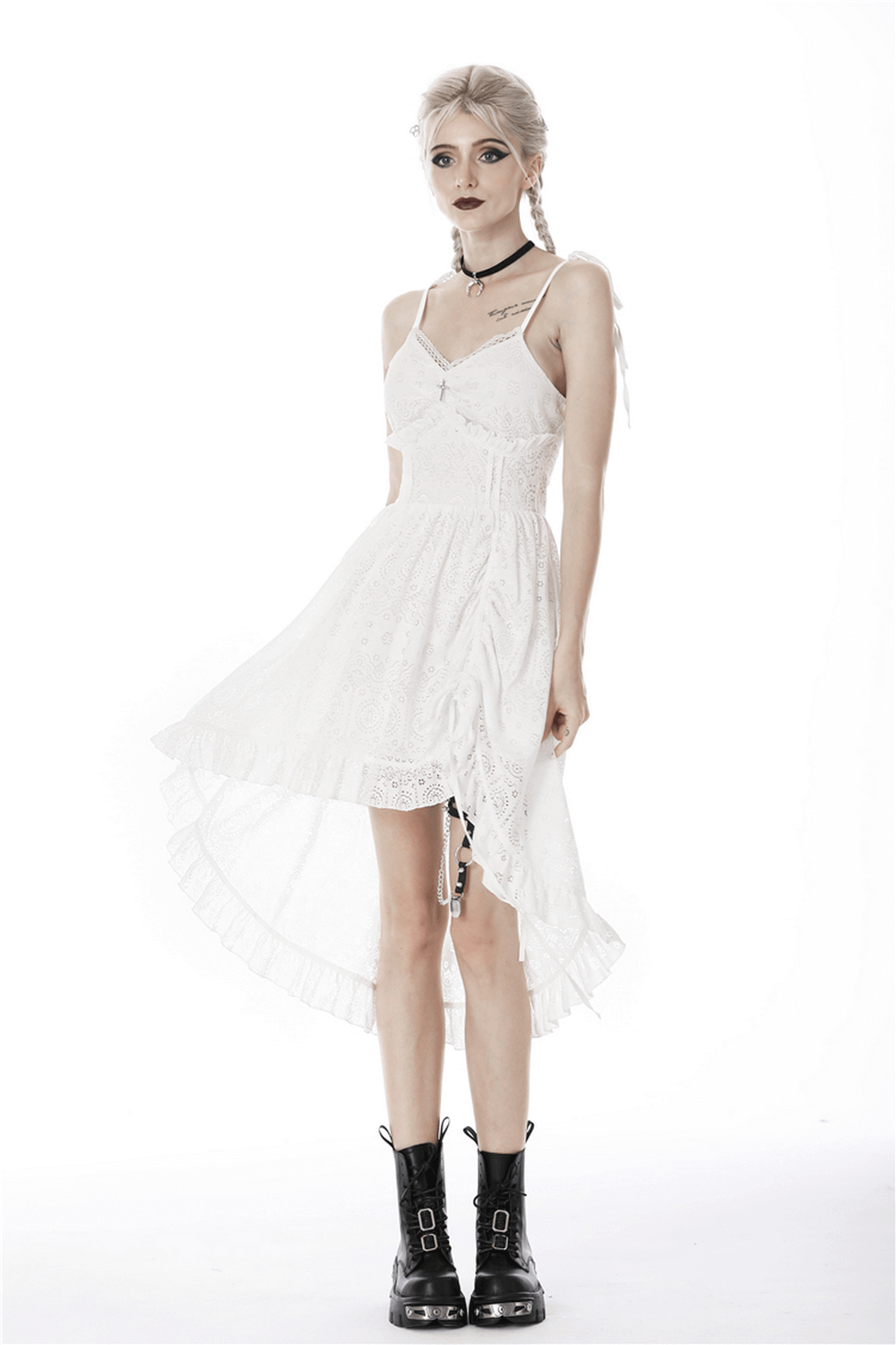 Gothic white lace midi dress with asymmetric hem, paired with bold black boots for a striking look.