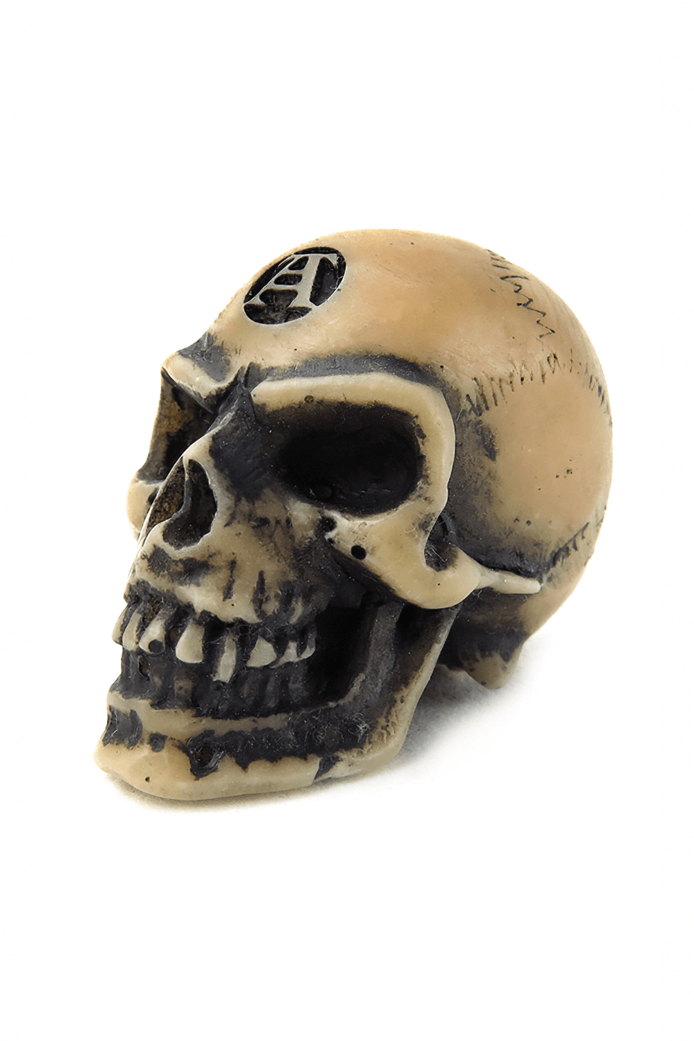 Tiny Lapillus skull worry stone with mystical symbols for gothic decor and worry relief.