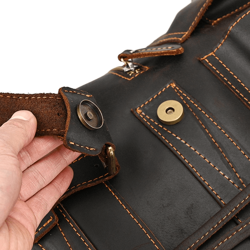 Close-up of durable leather backpack closure showing buckle detail and stitching, highlighting quality craftsmanship.