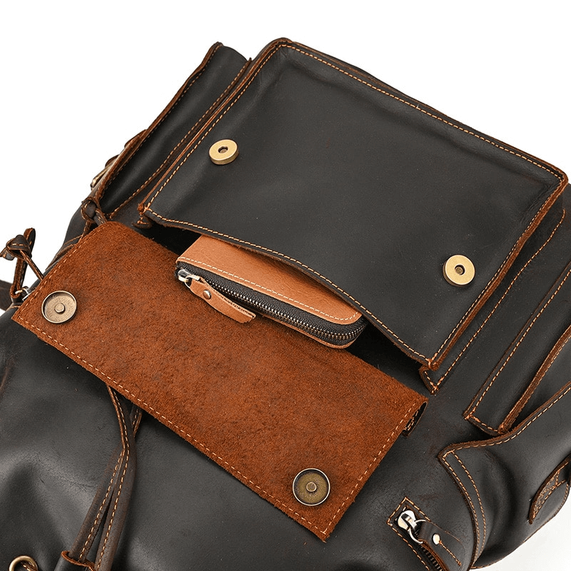 Interior view of a large genuine leather laptop travel backpack showcasing various pockets for organization.