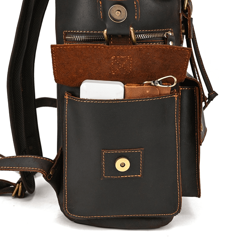 close-up of large genuine leather backpack showing pockets for phone and essentials, perfect for travel and daily use.