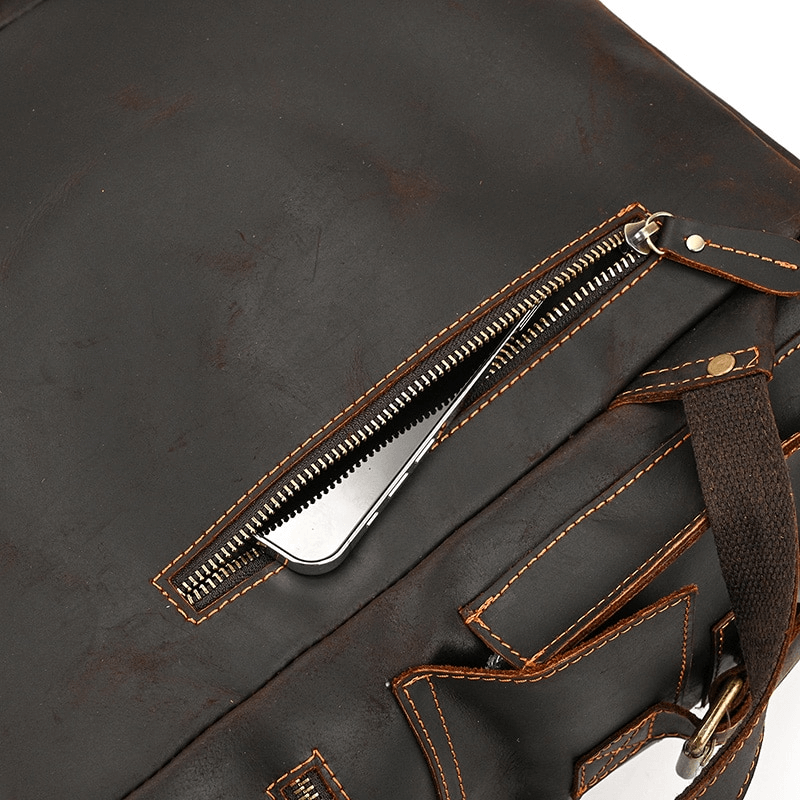Close-up of the sturdy zipper on a large genuine leather backpack, showcasing high-quality craftsmanship and functionality.
