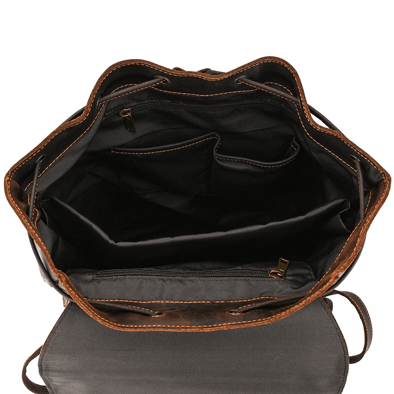 Interior view of a large genuine leather laptop backpack with multiple pockets for organization.