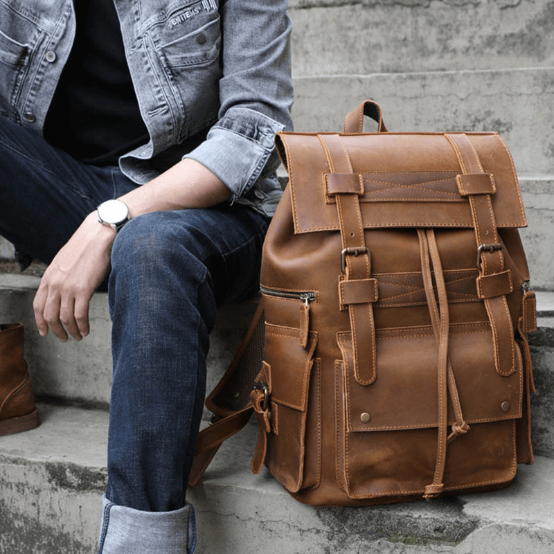 Stylish genuine leather laptop backpack, perfect for travel and daily use, featuring multiple pockets for organization.