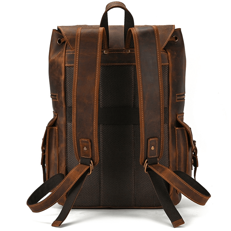 Large brown genuine leather laptop backpack with adjustable straps and multiple pockets for organized travel.