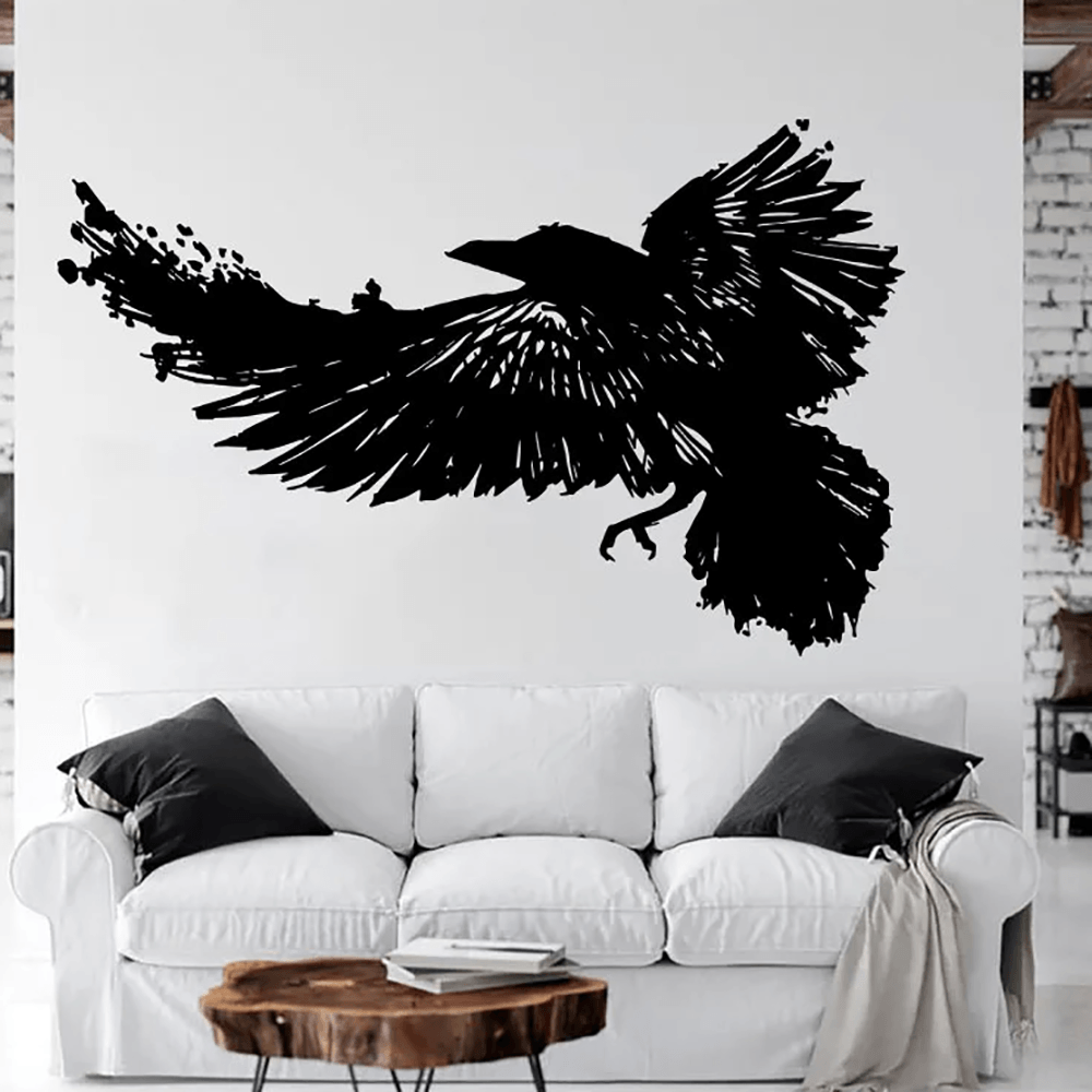Large Raven Bird Wall Sticker for Gothic Room Decor - striking flying crow vinyl wall decal on a white wall above a couch.