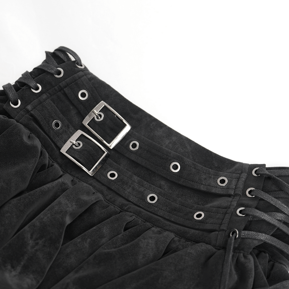 Close-up of gothic skirt waistband featuring adjustable lacing and stylish double buckle details in black fabric.