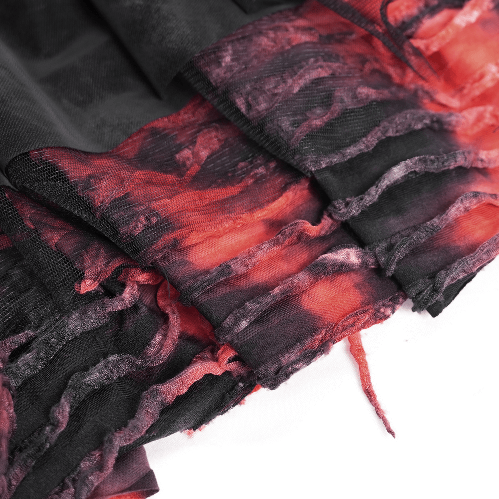 Close-up of layered asymmetrical goth skirt in black and red tulle, showcasing edgy lace details and tiered design.