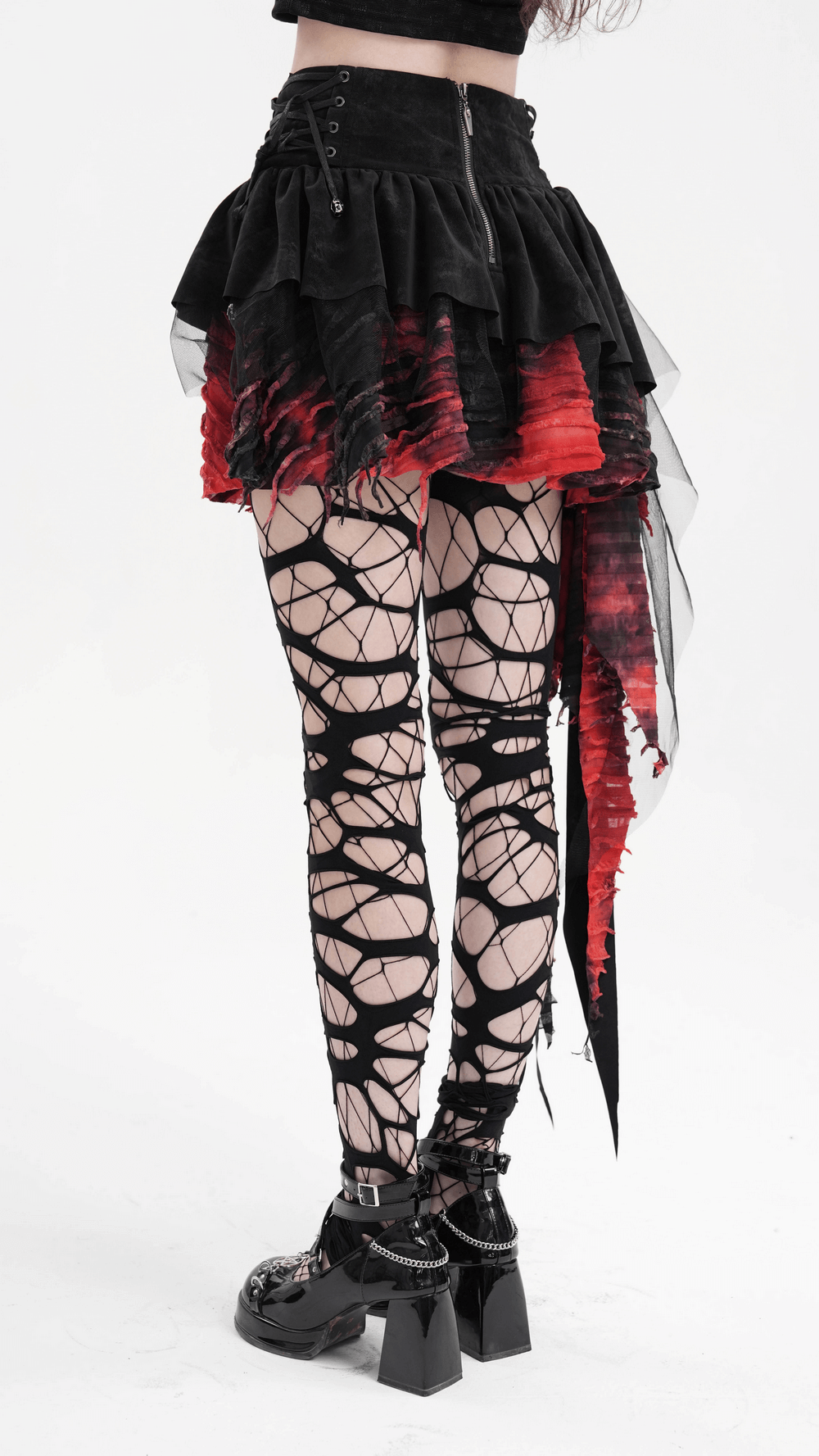 Edgy layered asymmetrical gothic skirt in red and black with lace, paired with striking fishnet tights for alternative style.