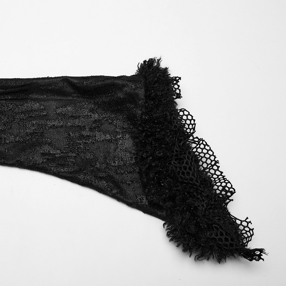 Close-up of black lace trim detailing on a sleeve, showcasing gothic elegance and intricate design.