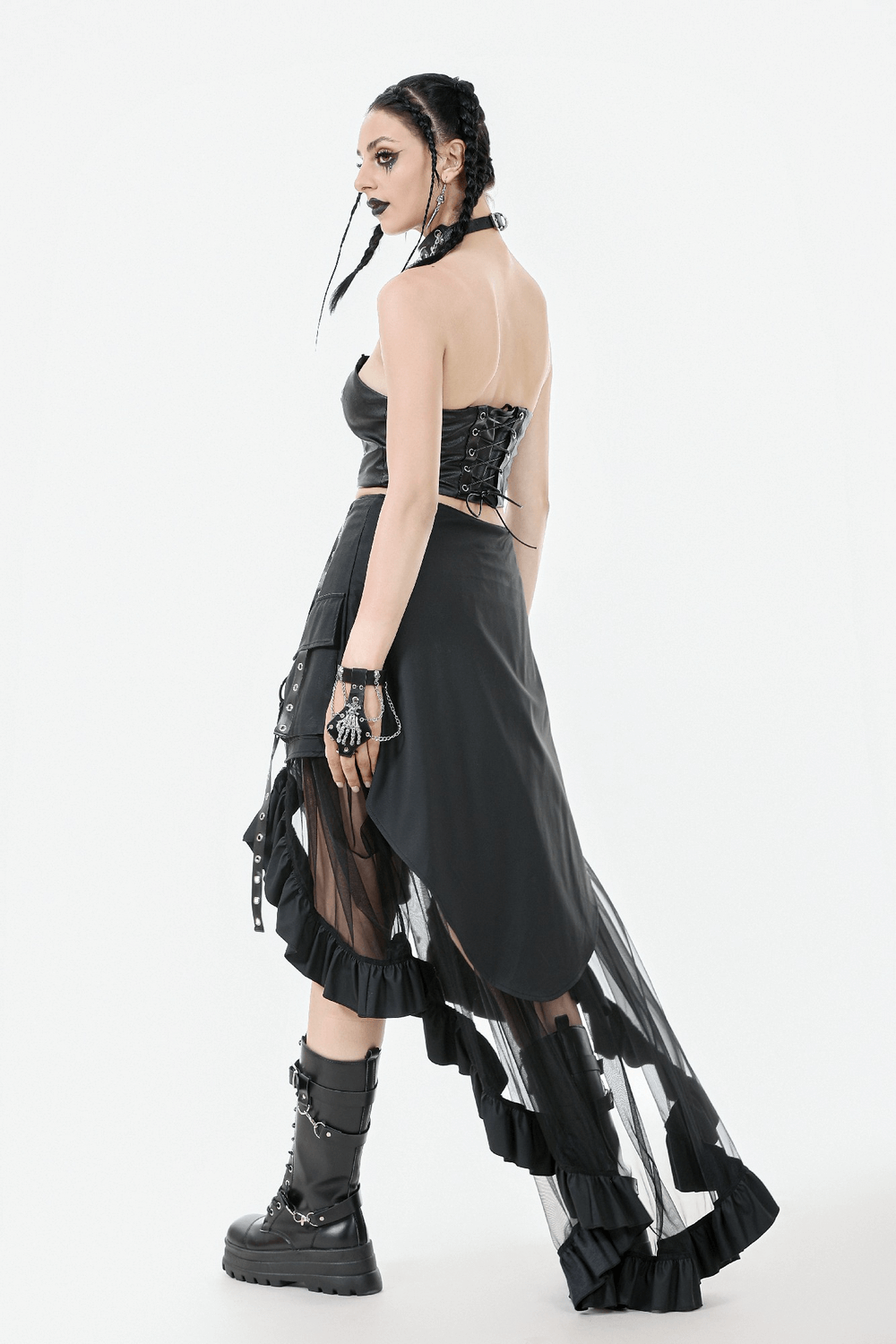 Model showcasing a black layered mesh high-low ruffle skirt with punk styling and adjustable straps.