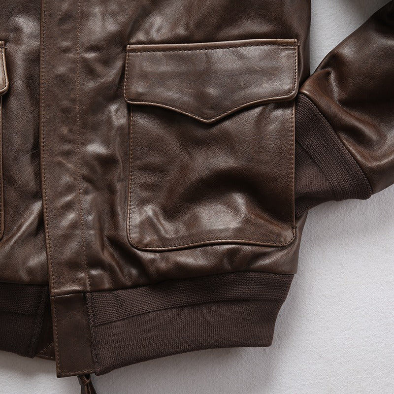 Brown leather biker jacket with pockets and ribbed cuffs, perfect for a rock-inspired outfit.