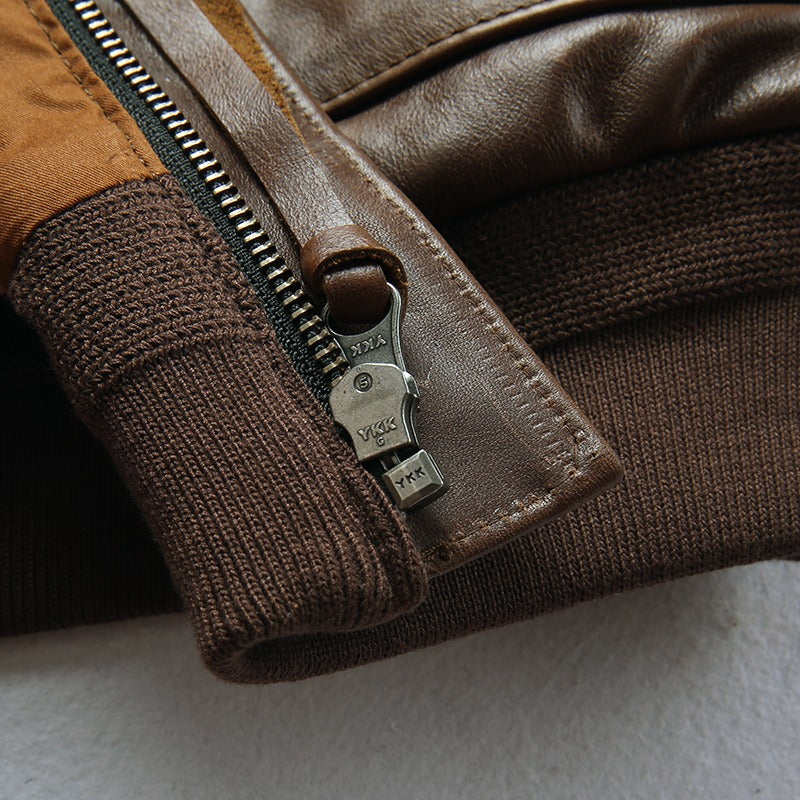 Close-up of a leather biker jacket zipper, showcasing durable stitching and elastic cuffs for a stylish fit.