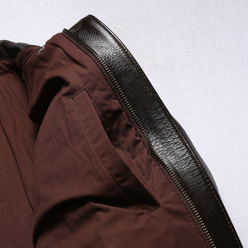 Interior view of a men's leather biker jacket with a sleek black finish and fabric lining, showcasing side pocket and zipper details.