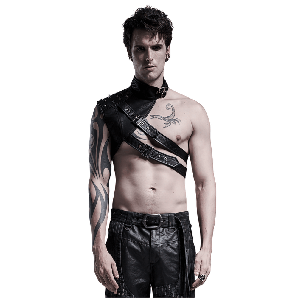 Edgy punk-style man wearing a one-arm leather shoulder harness with metal rivets and tattoos.