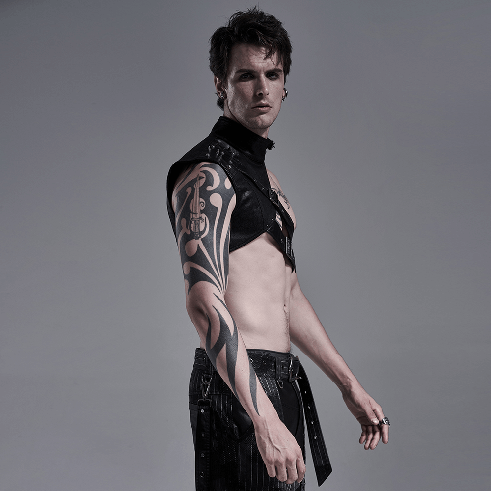 Model showcasing a punk leather shoulder harness, featuring bold tattoos and edgy fashion flair.