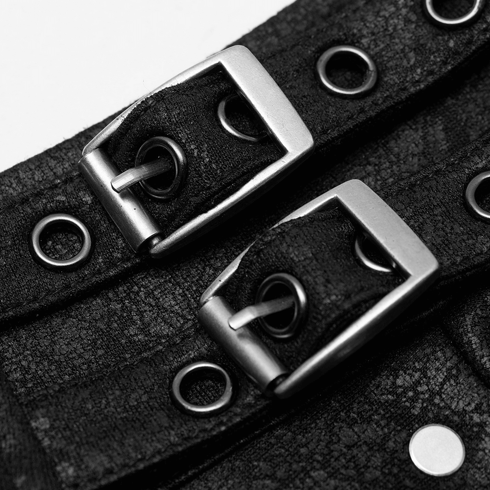 Close-up of metal buckles and eyelets on a textured black leather harness, perfect for edgy streetwear.
