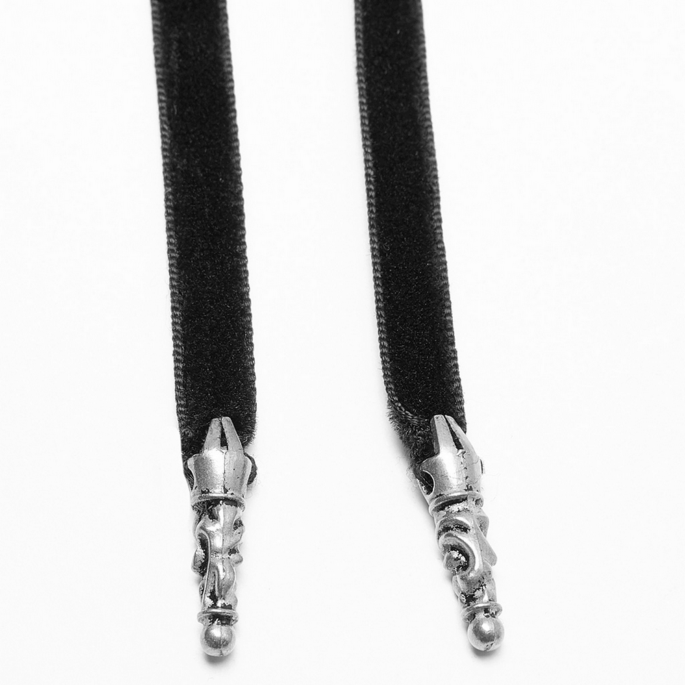 Close-up of gothic black velvet ribbon with silver dragon tips, perfect for adding a mystical touch to any outfit.
