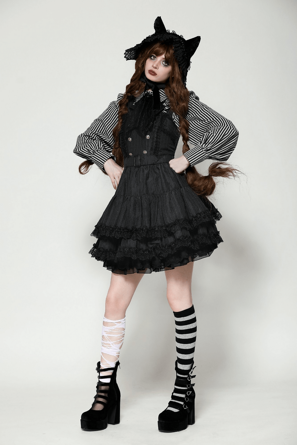 Black Gothic Lolita dress with lace ruffles, decorative buttons, and striped leggings for a dramatic vintage look.