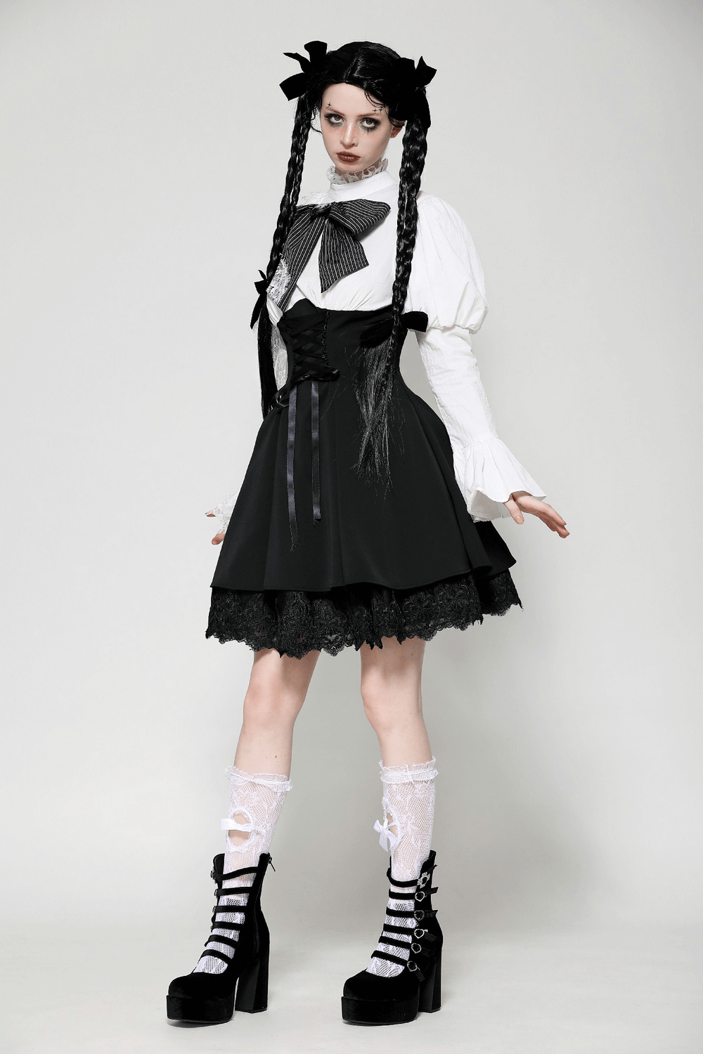 Elegant black and white Lolita dress with lace sleeves, corset waist, and gothic accessories for a striking alternative fashion look.