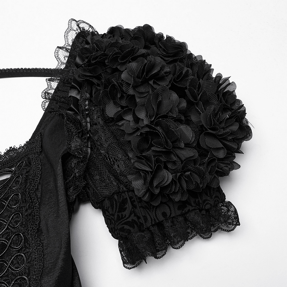Close-up of black puff sleeve with floral lace detailing on a gothic dress.