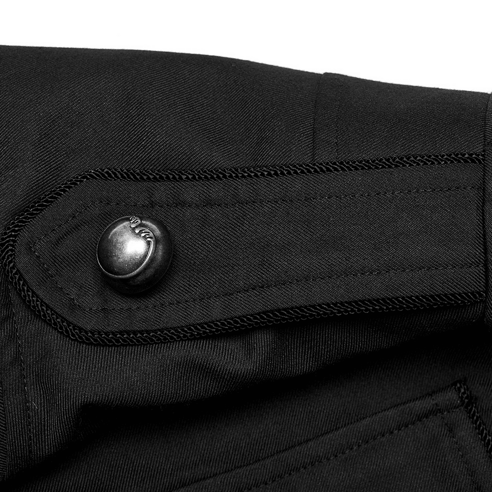 Close-up of the button detailing on a long black military-style trench coat for men.