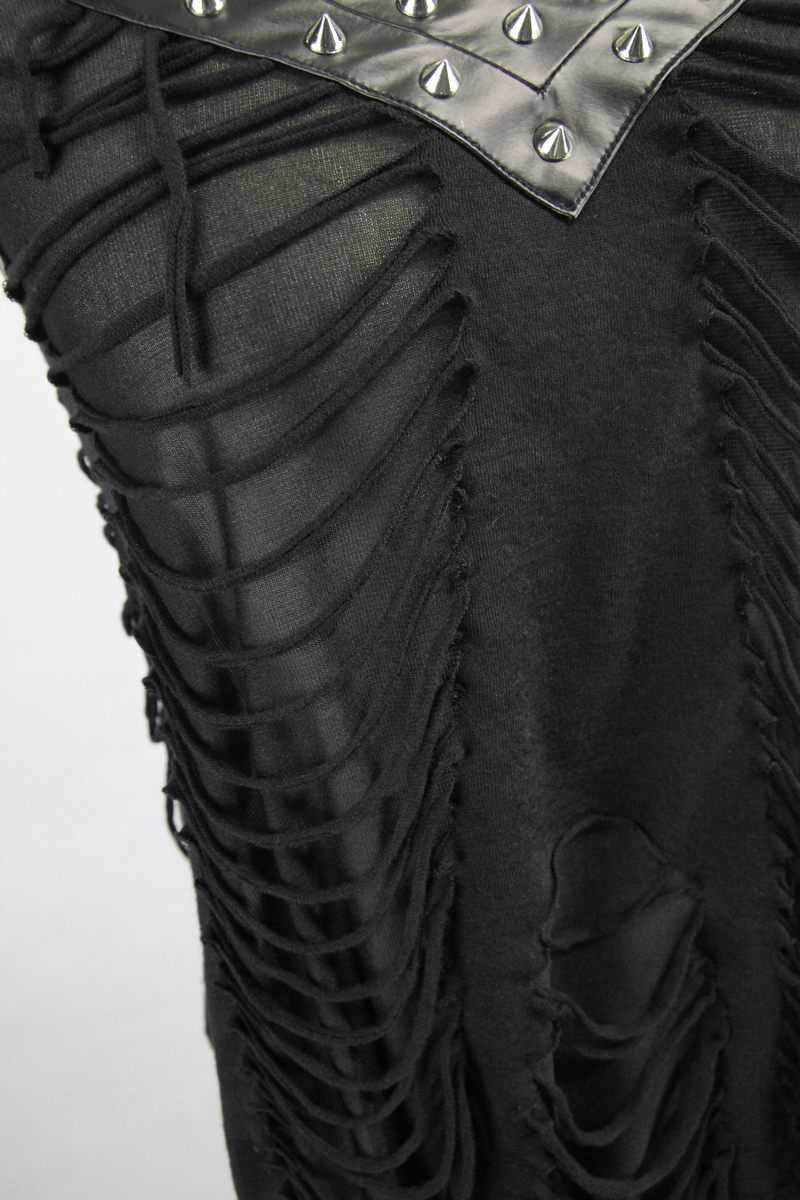 Close-up of a black top with ripped design and silver spikes, showcasing punk-inspired fashion.