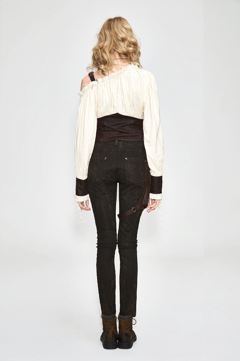 Back view of a stylish long sleeve beige blouse with lacing, paired with black skinny jeans, showcasing alternative fashion.