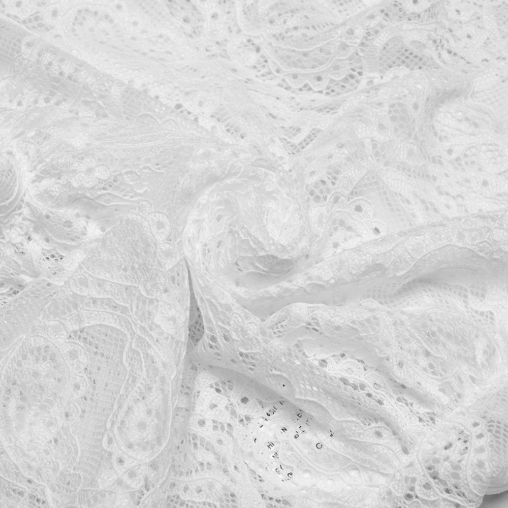 Close-up of intricate white lace fabric showcasing floral patterns, perfect for elegant clothing.