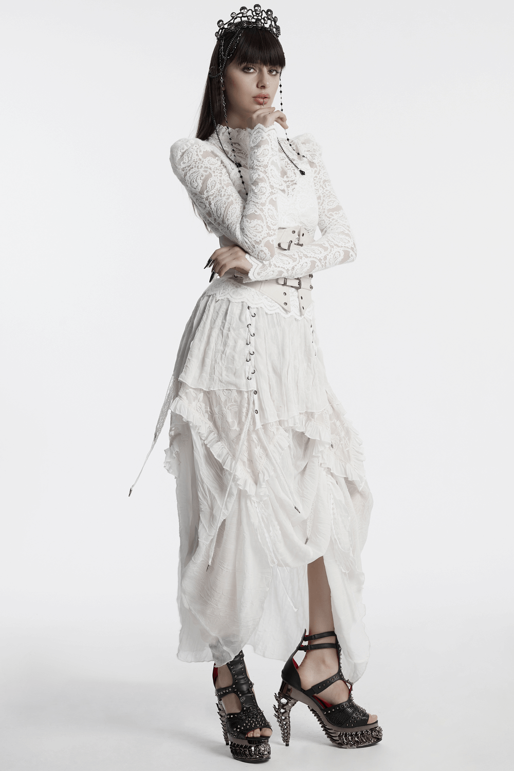 Gothic long-sleeve white lace blouse with ruffled collar, paired with layered skirt and stylish platform heels.