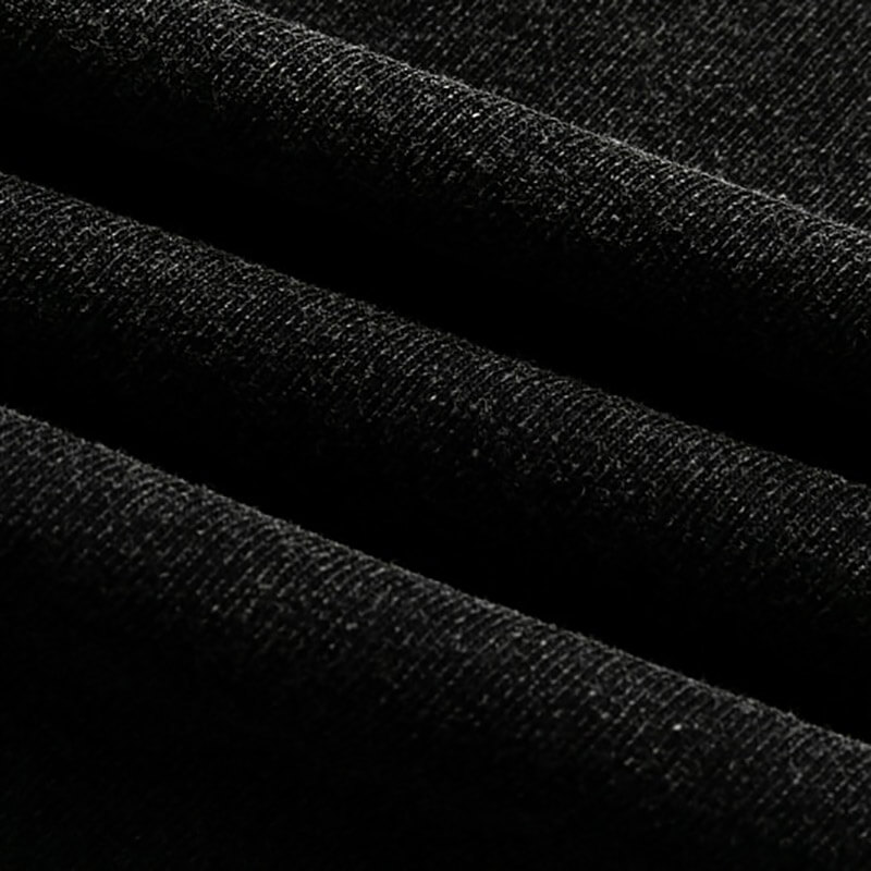Close-up of soft black cotton fabric showcasing the texture for a loose gothic style t-shirt.