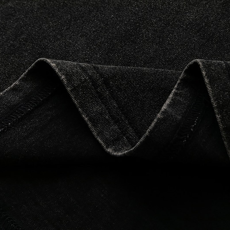 Detail of soft black cotton fabric showcasing the elegant drape of a loose T-shirt ideal for gothic fashion.